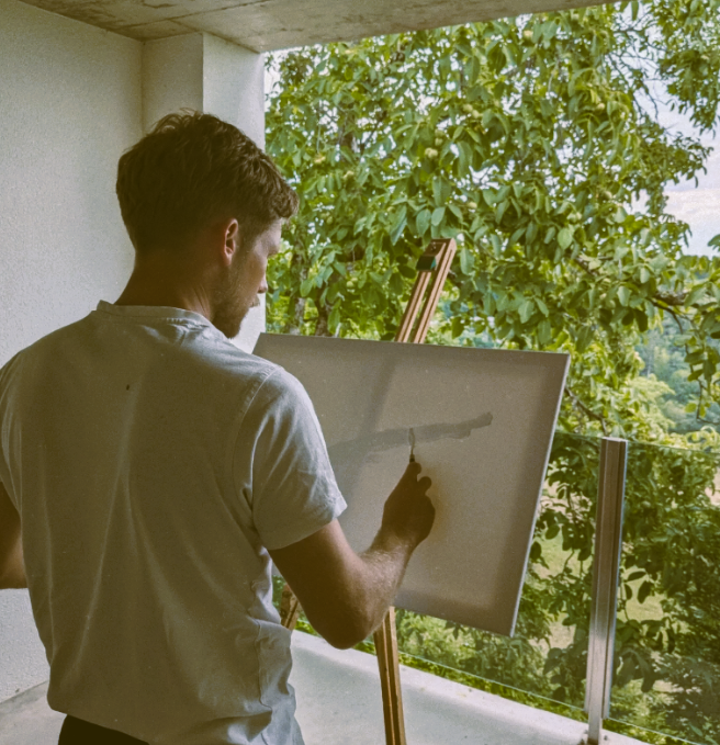 The artist painting on a canvas